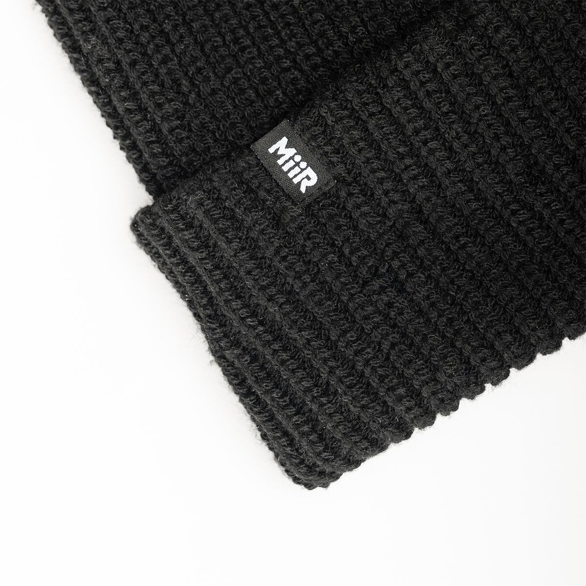 recycled-poly-rib-beanie-v5 WebPDP-RecycledPolyRibBeanie_Studio_TagDetail_Black__BNE002002OS.jpg